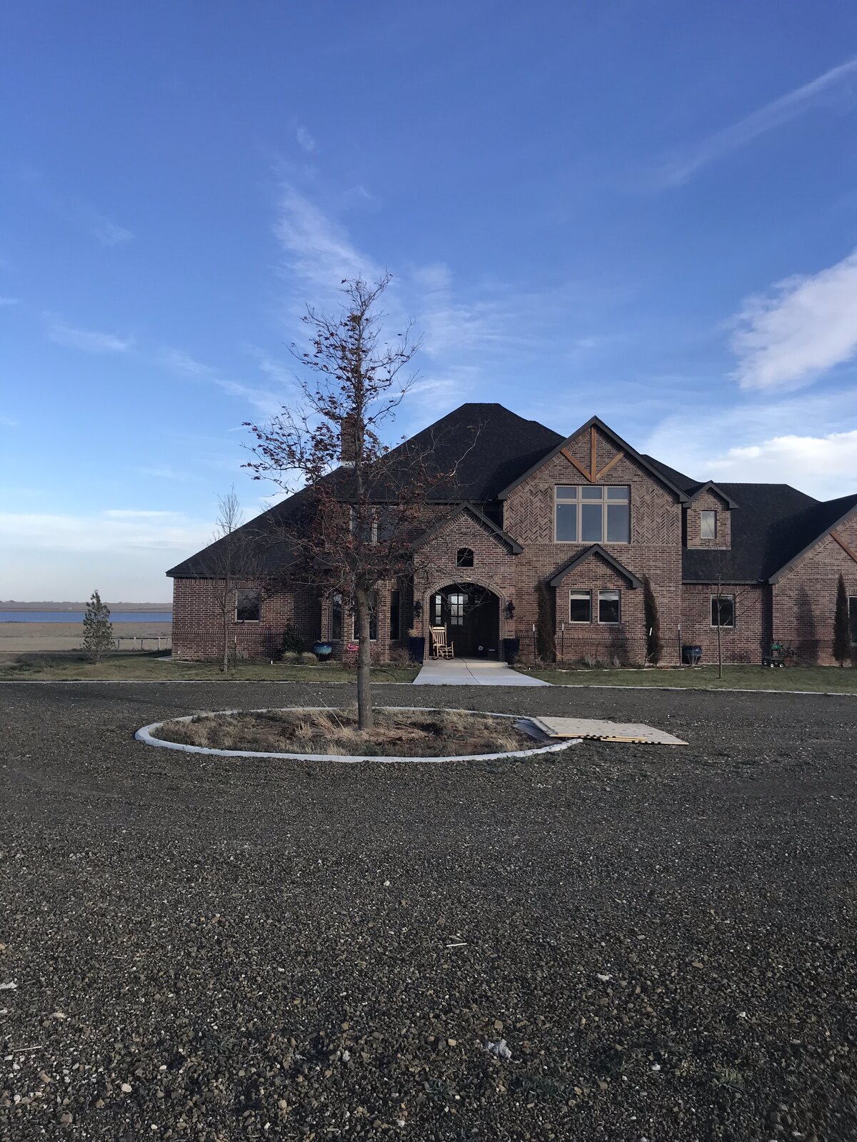 Same brick estate with mature tree planted