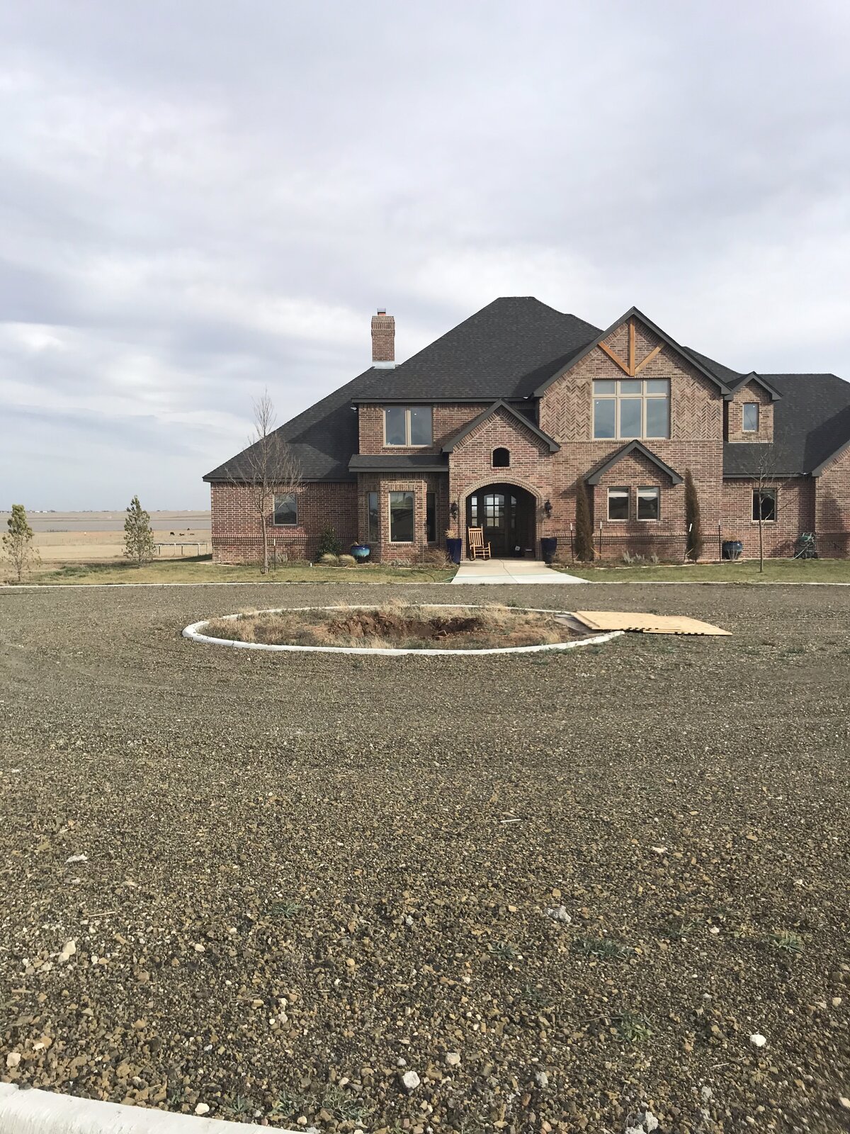 Brick estate with empty prepped tree bed